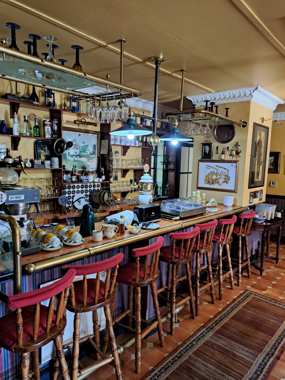 Honesty bar with brass fittings and wooden bar stools
