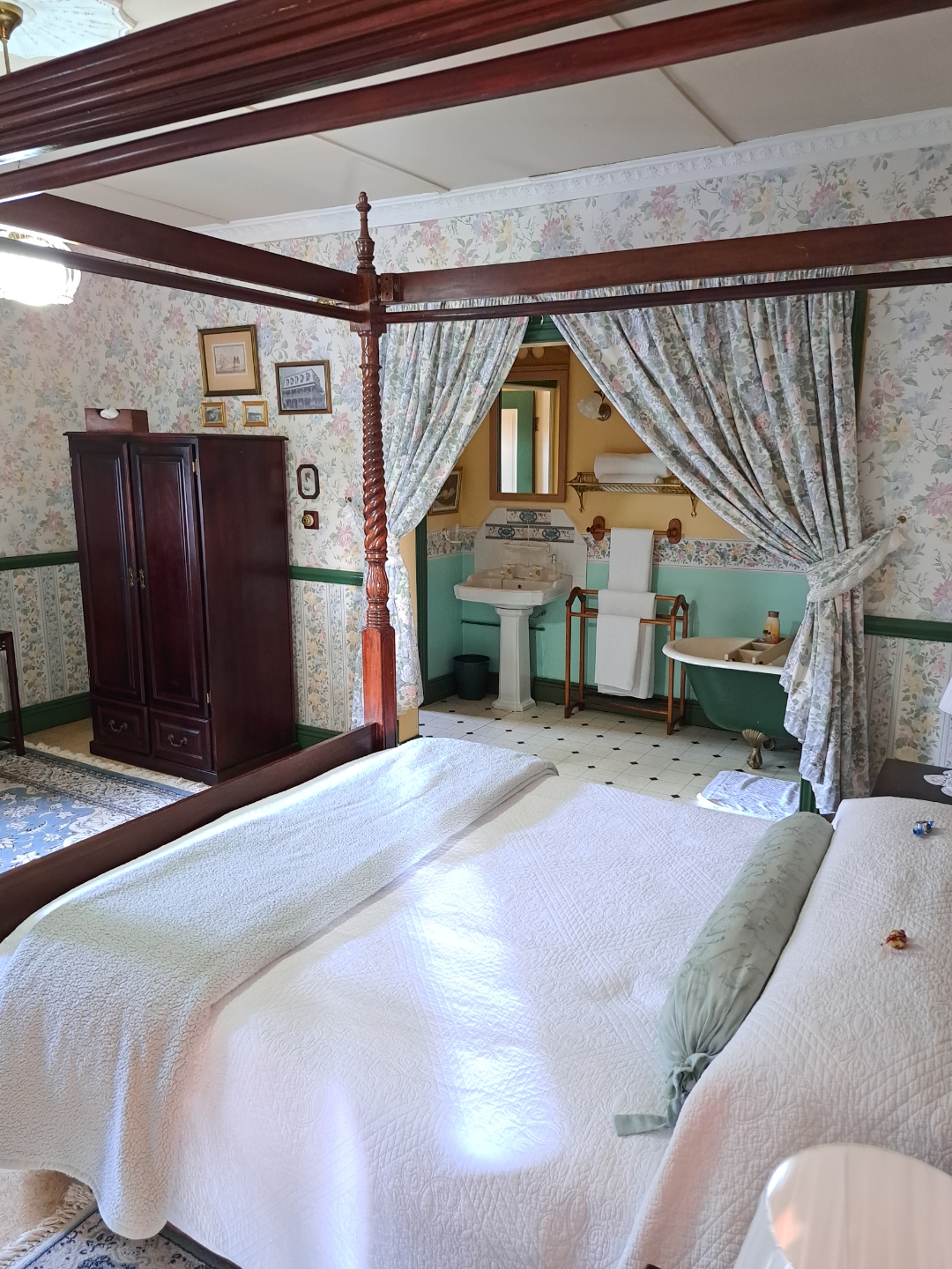 Family Room — four-poster bed with floral curtains