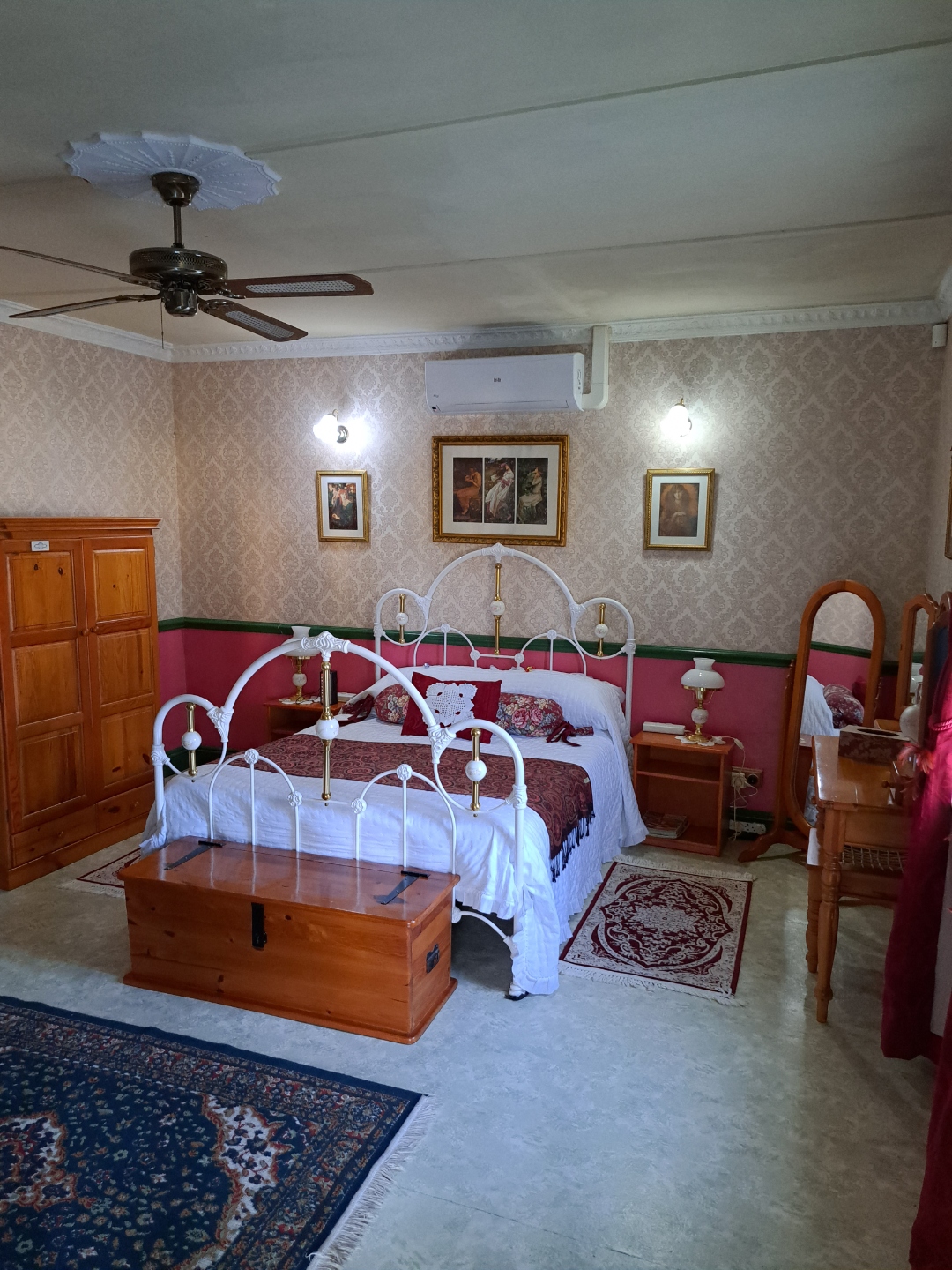 Deluxe Red Room — white iron bed with burgundy accents