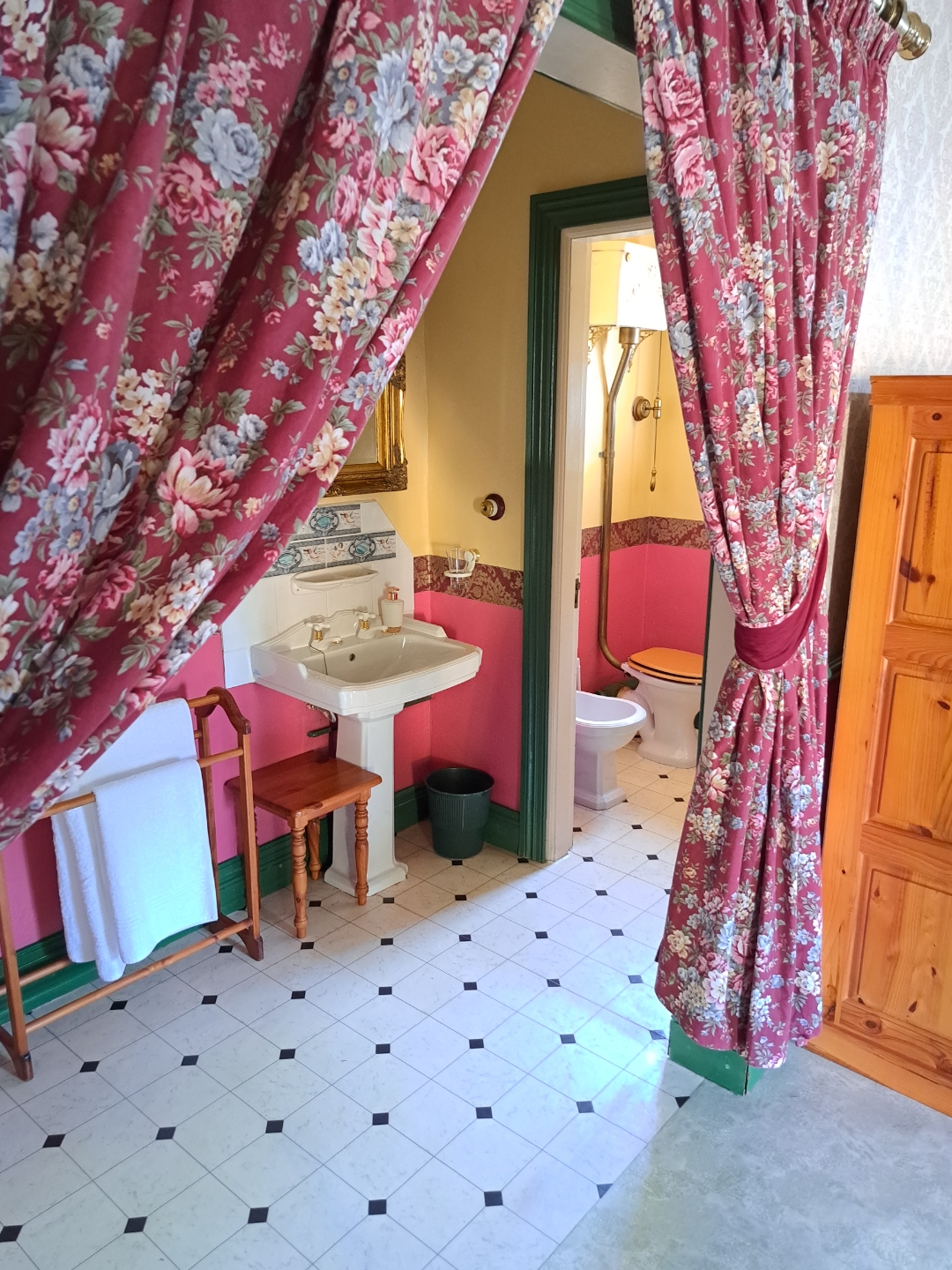Deluxe Red Room — pink bathroom with period basin