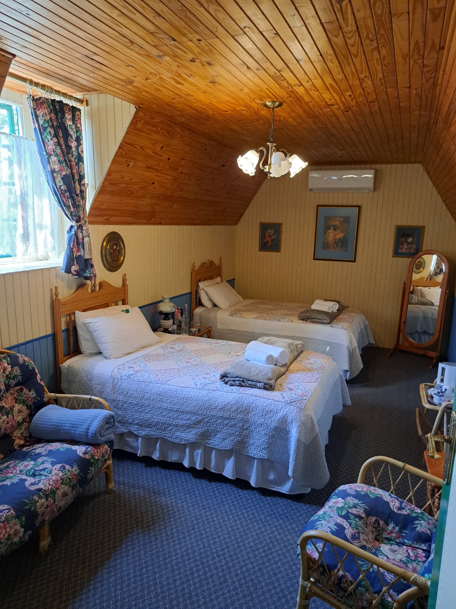 Twin Room — two beds with pine ceiling and Victorian chandelier